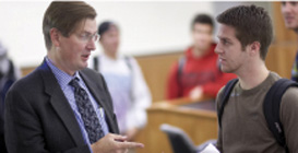 Photo of a teacher and student talking Photo of a teacher and student talking
